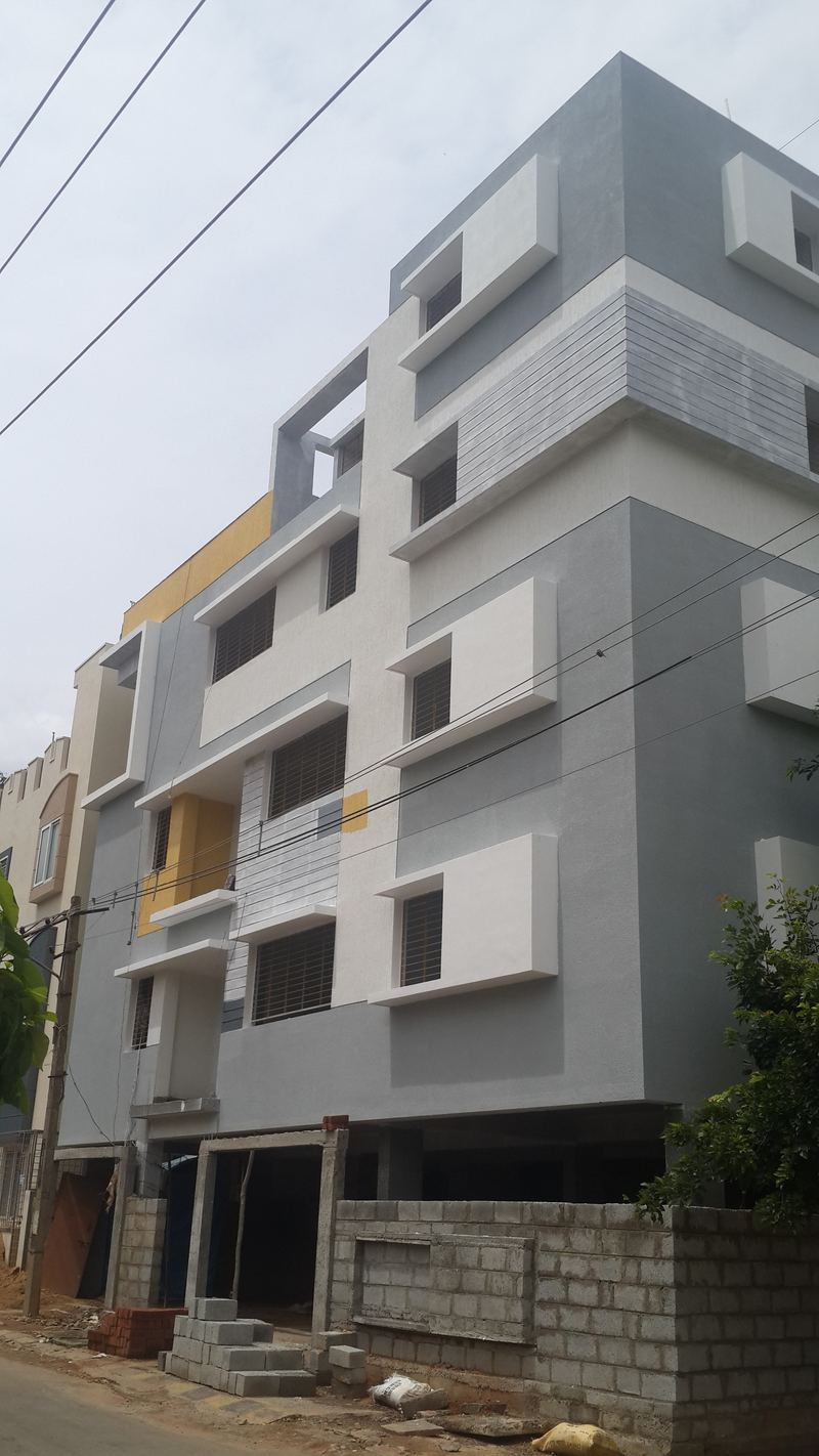 Completed grey and white apartment building on a Bangalore street