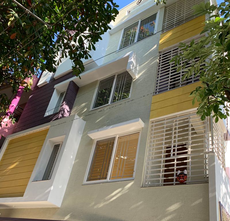 Completed apartment building with yellow and plum façade panels in Bangalore