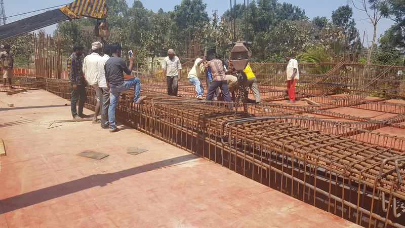 Site team tying slab reinforcement on a curved concrete floor